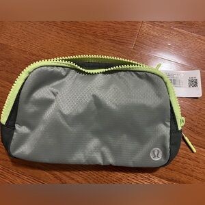 New Lululemon Everywhere Belt Bag
Gray with yellow/green zipper